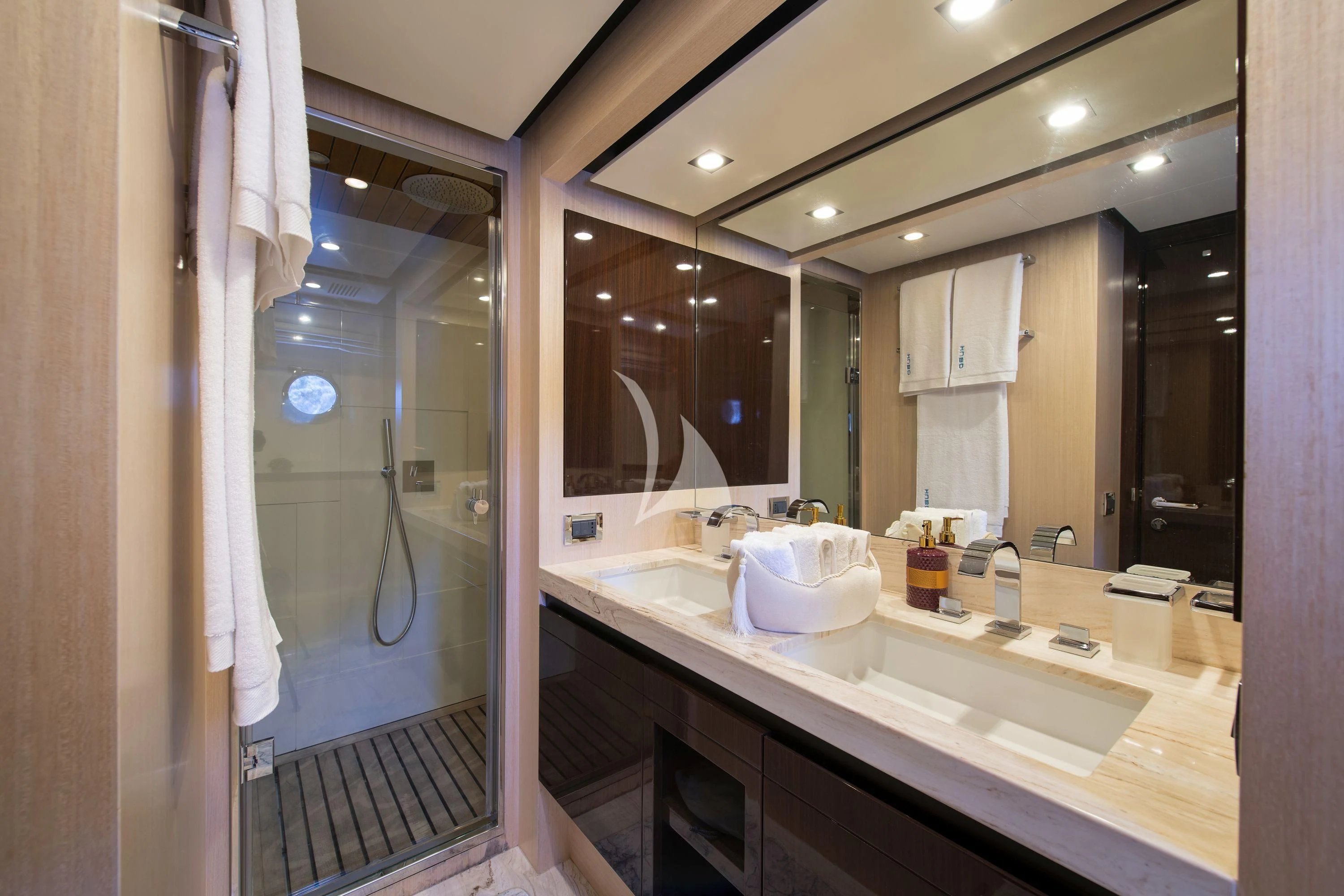 a bathroom with a large mirror aboard HUBO Yacht for Sale
