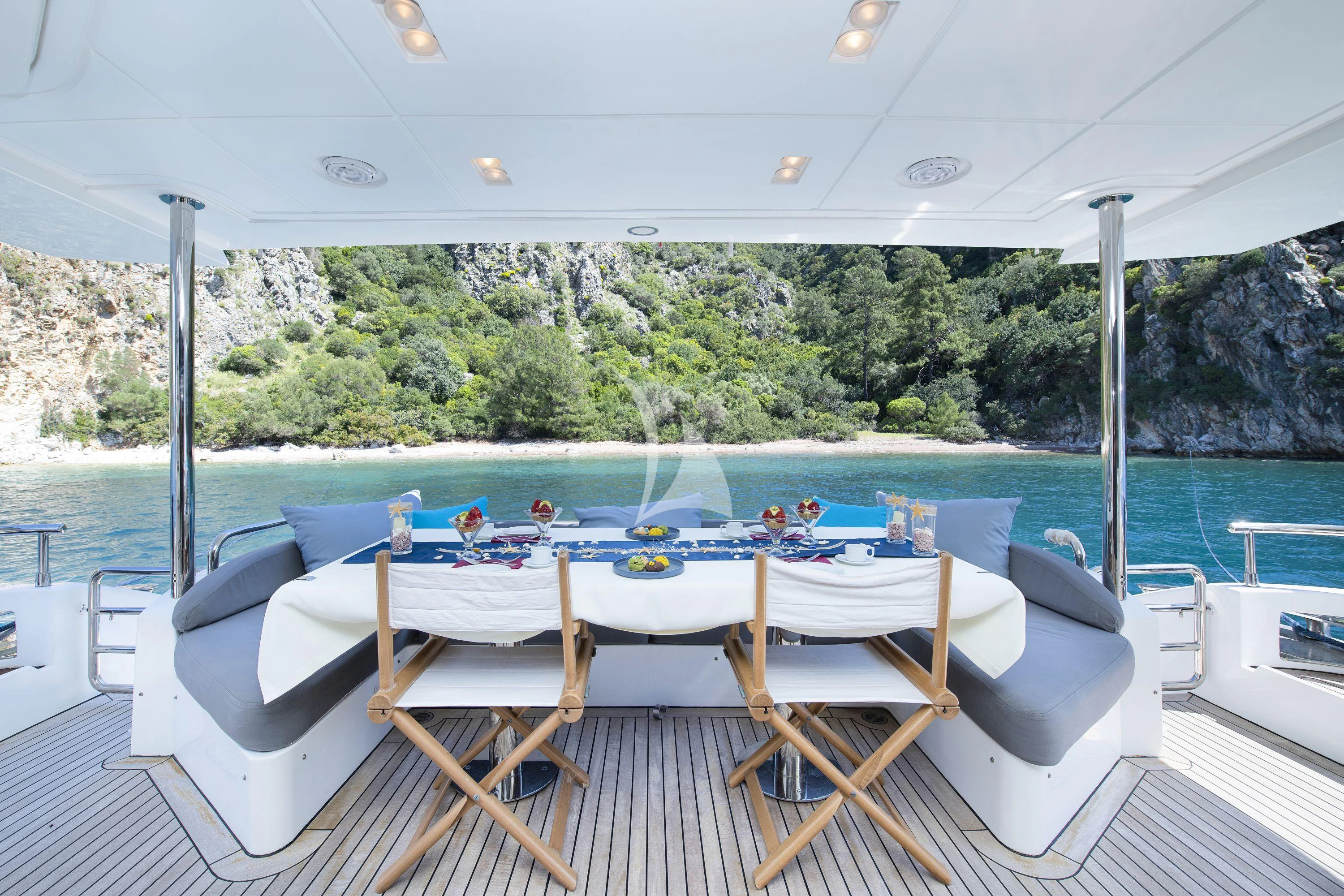 a pool with a deck and chairs aboard HUBO Yacht for Sale