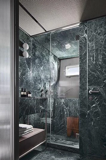 a bathroom with a glass shower aboard SUNDANCE Yacht for Sale