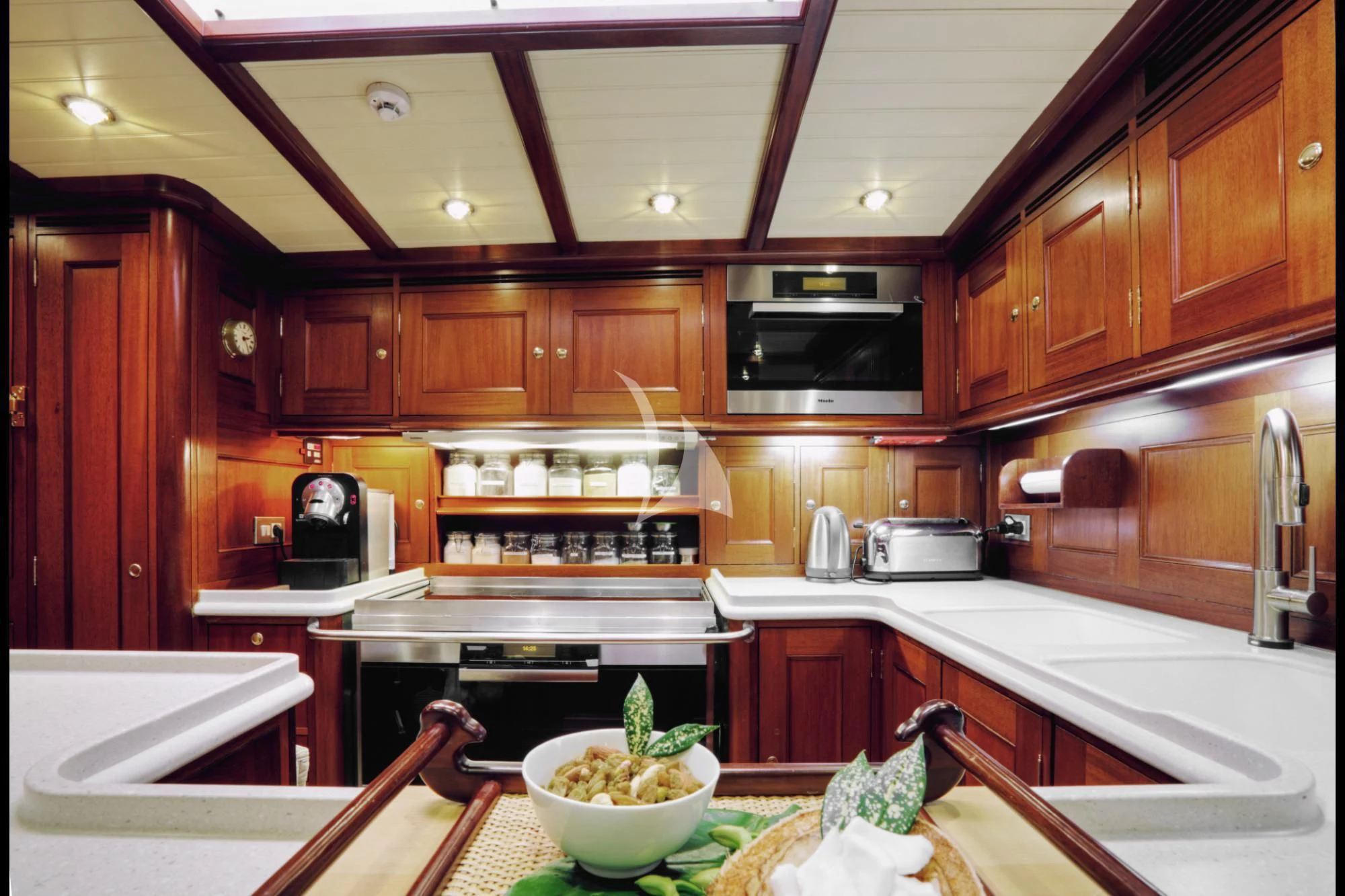 a kitchen with wooden cabinets aboard SHAMOUN Yacht for Sale