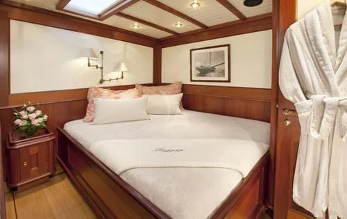 a bed with white sheets aboard SHAMOUN Yacht for Sale