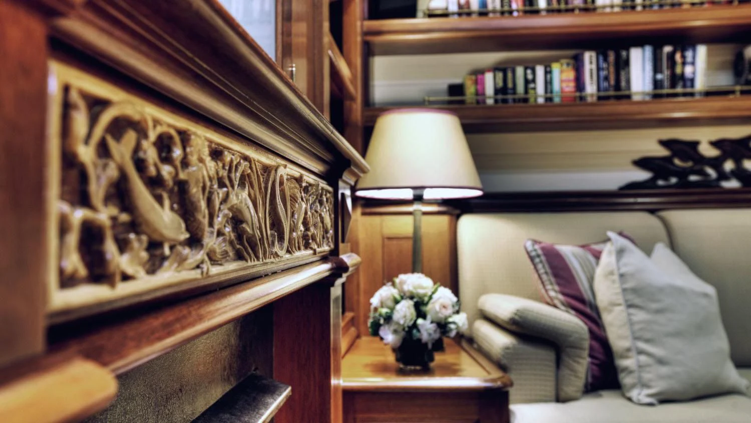 a room with a couch and a lamp and a bookcase aboard SHAMOUN Yacht for Sale