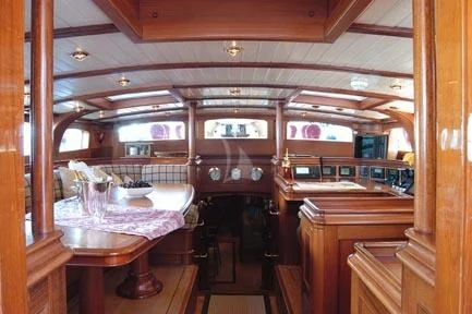 a room with a table and chairs aboard SHAMOUN Yacht for Sale