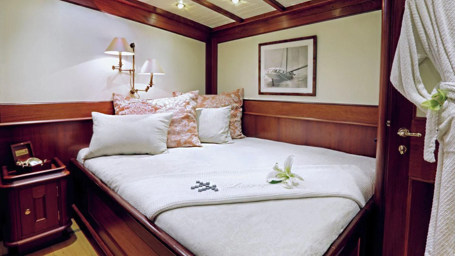 a bed with a white sheet and pillows aboard SHAMOUN Yacht for Sale
