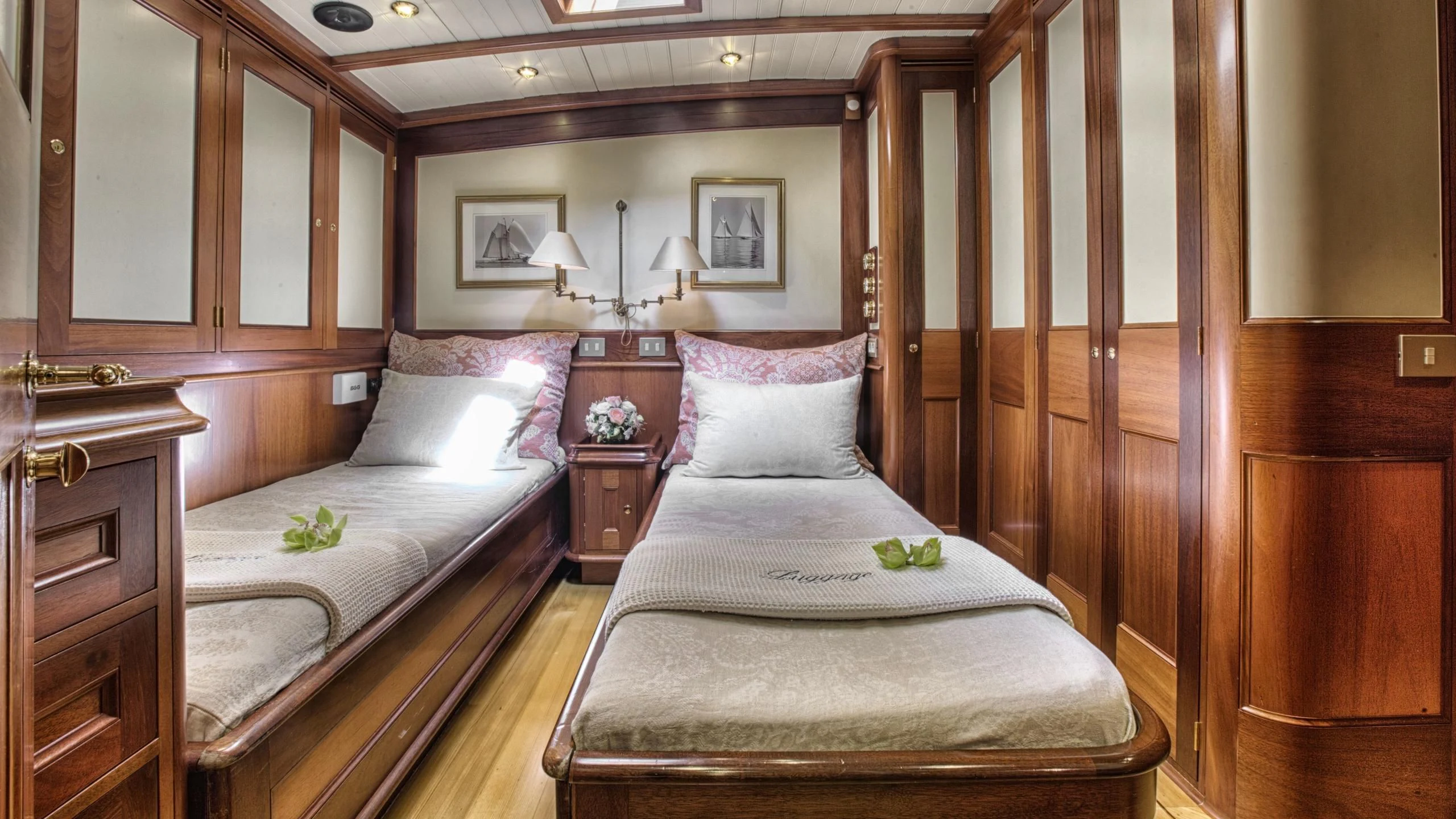 a bed with a white pillow and a wooden wall aboard SHAMOUN Yacht for Sale