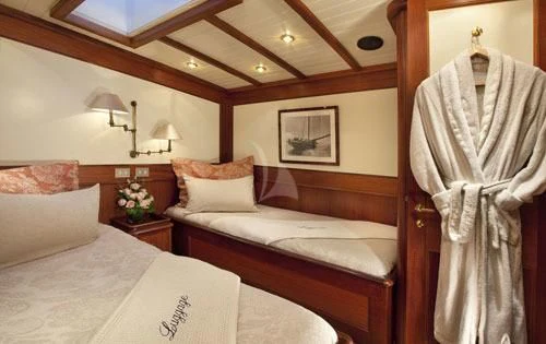 a couple of beds in a hotel room aboard SHAMOUN Yacht for Sale
