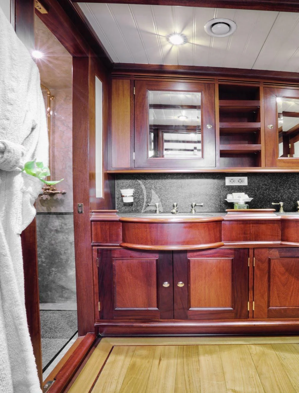 a kitchen with wooden cabinets aboard SHAMOUN Yacht for Sale