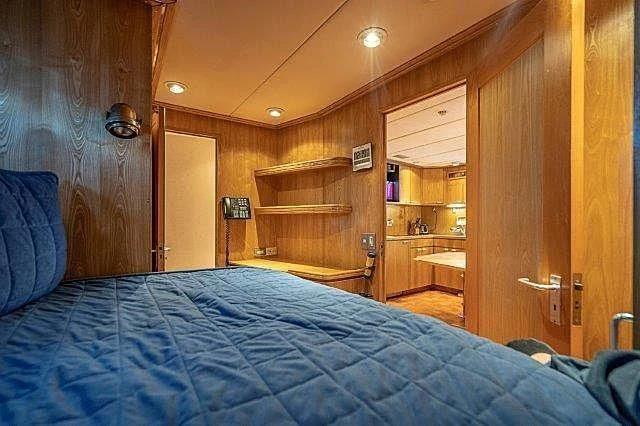 a bedroom with a bed and a closet aboard IVORY LADY Yacht for Sale