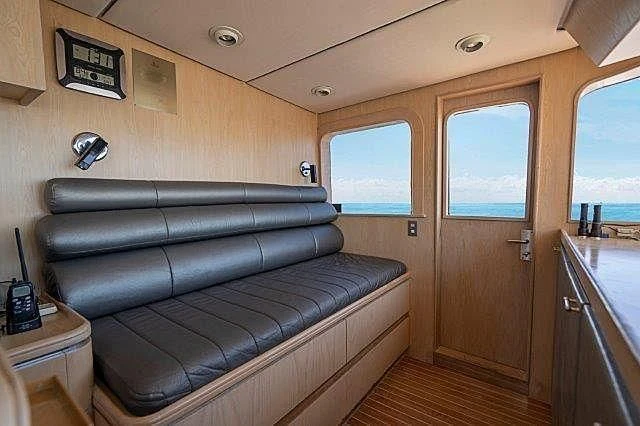 a living room with a leather couch aboard IVORY LADY Yacht for Sale