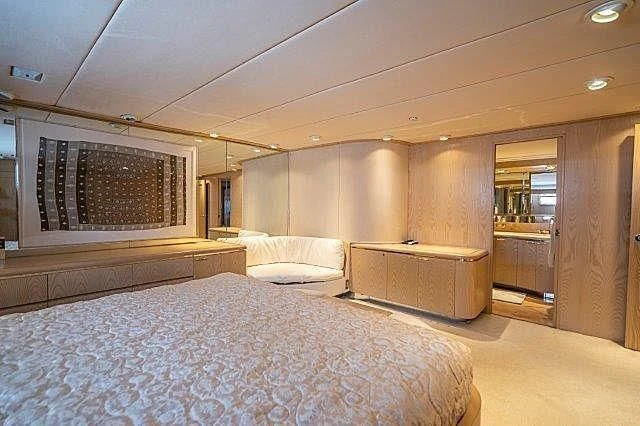 a room with a bed and a television aboard IVORY LADY Yacht for Sale