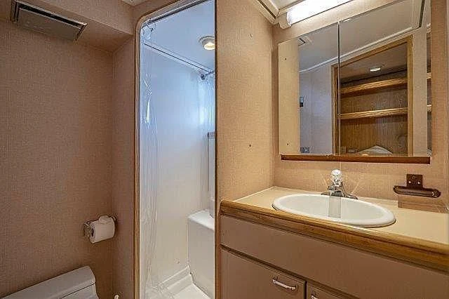 a bathroom with a sink and a mirror aboard IVORY LADY Yacht for Sale