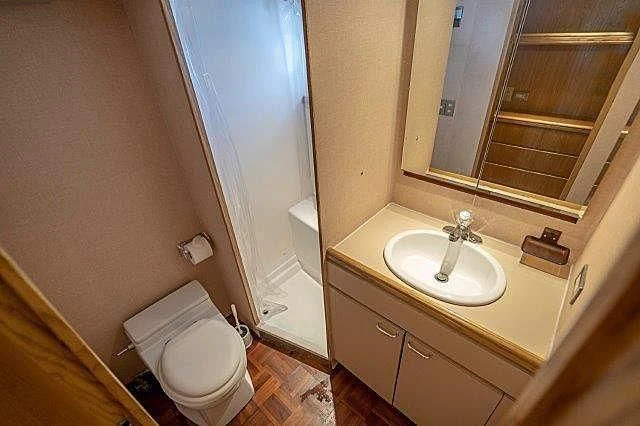 a bathroom with a toilet and a sink aboard IVORY LADY Yacht for Sale