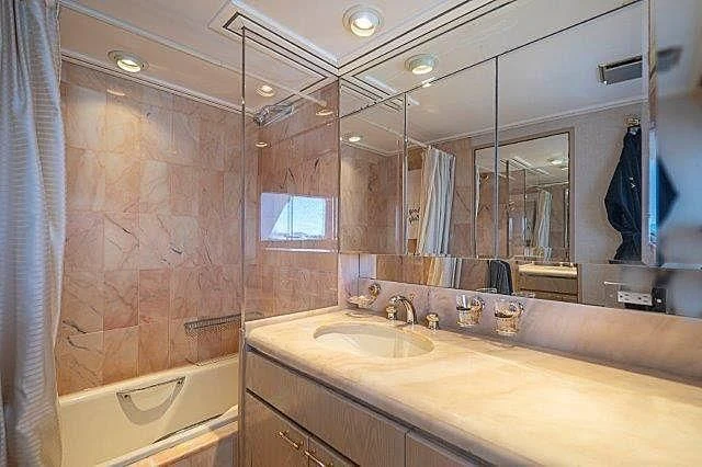 a bathroom with a large mirror aboard IVORY LADY Yacht for Sale