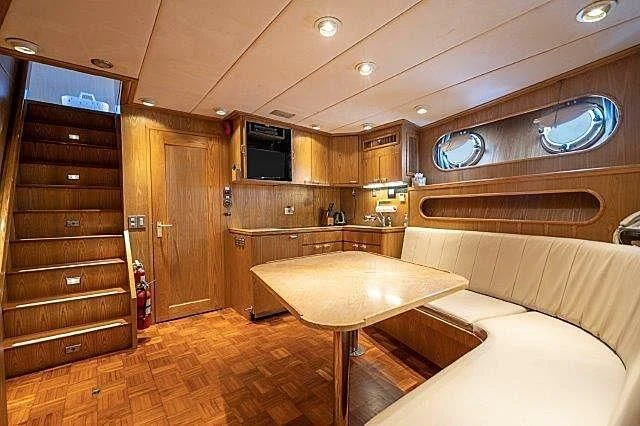a room with a table and a couch aboard IVORY LADY Yacht for Sale
