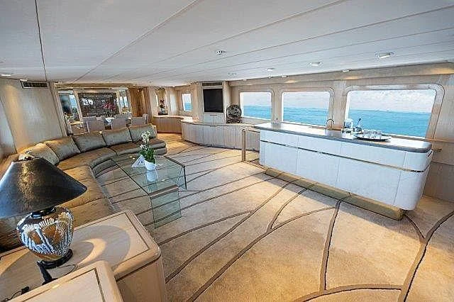 a large living room with a pool table and a large window aboard IVORY LADY Yacht for Sale