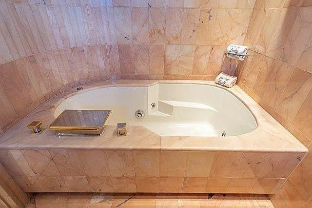 a bathtub with a book on it aboard IVORY LADY Yacht for Sale