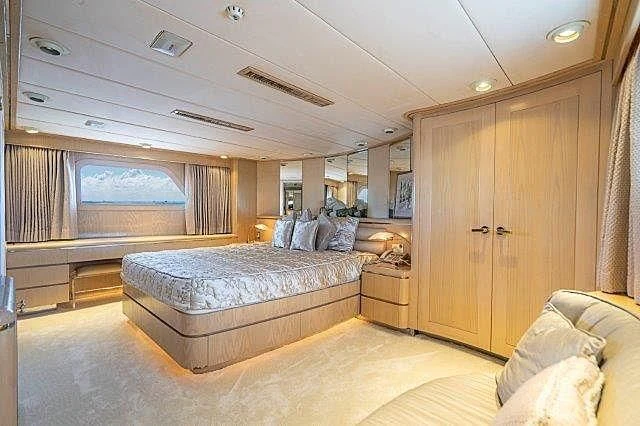 a large bedroom with a bed aboard IVORY LADY Yacht for Sale