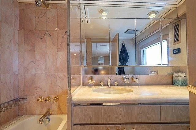 a bathroom with a large mirror aboard IVORY LADY Yacht for Sale