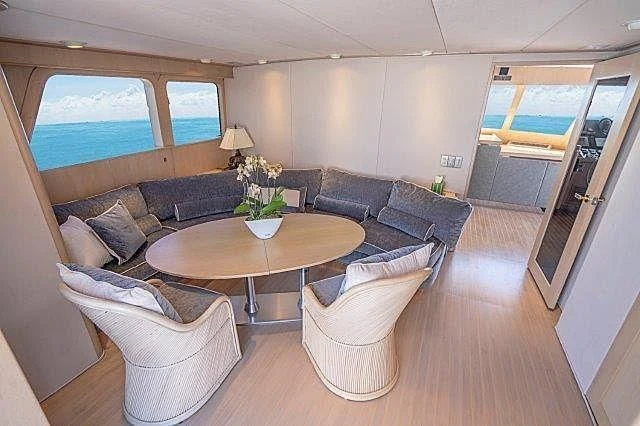 a living room with a couch and a coffee table aboard IVORY LADY Yacht for Sale