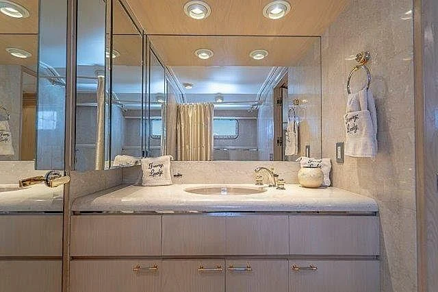 a bathroom with a large mirror aboard IVORY LADY Yacht for Sale