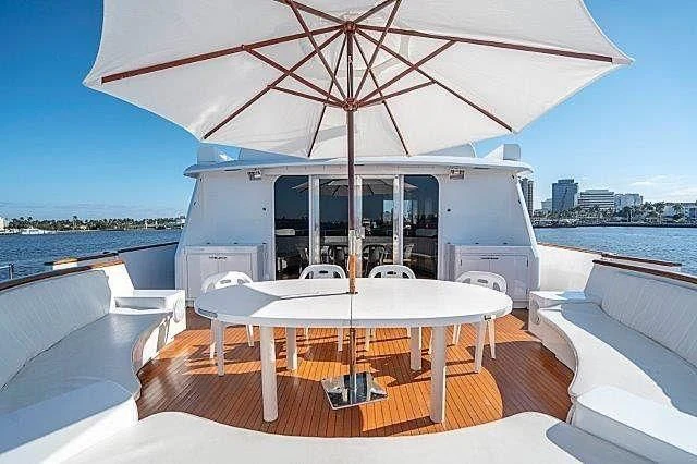a lounge area with a large umbrella aboard IVORY LADY Yacht for Sale