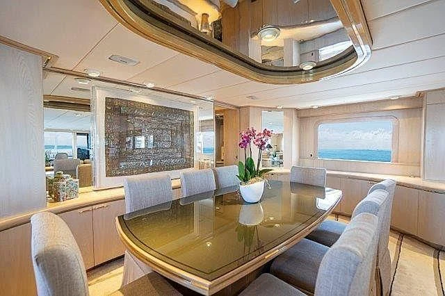a dining room with a table aboard IVORY LADY Yacht for Sale