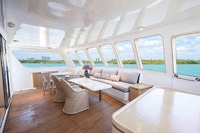 a living room with a table and chairs aboard IVORY LADY Yacht for Sale