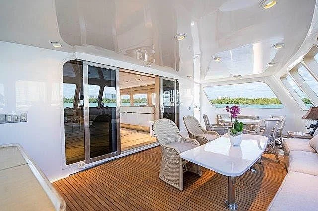 a room with a table chairs and a large window aboard IVORY LADY Yacht for Sale