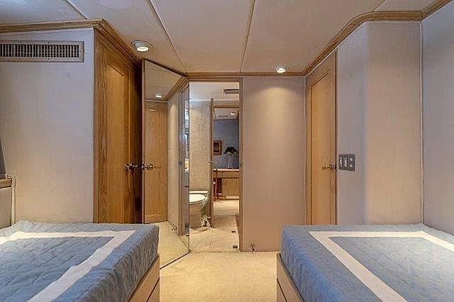 a room with a bed and a closet aboard IVORY LADY Yacht for Sale