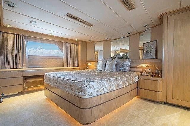 a room with a bed and a wood cabinet aboard IVORY LADY Yacht for Sale