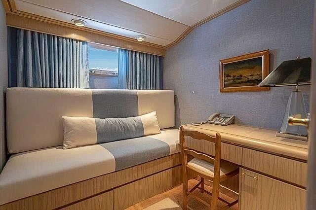 a living room with a couch and a desk aboard IVORY LADY Yacht for Sale