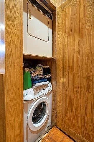 a closet with clothes on it aboard IVORY LADY Yacht for Sale