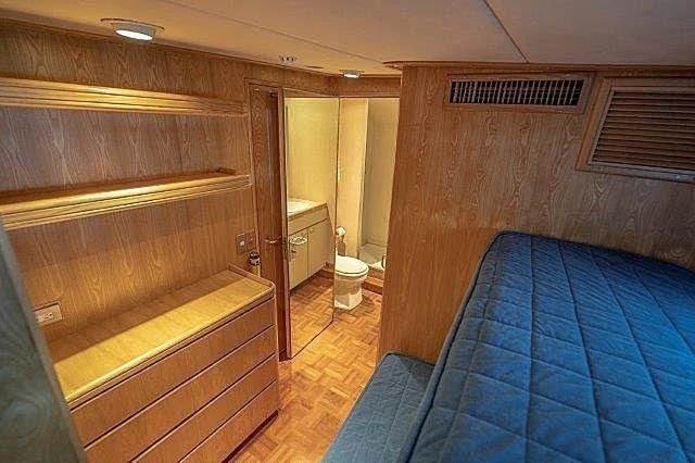 a bathroom with a blue rug aboard IVORY LADY Yacht for Sale