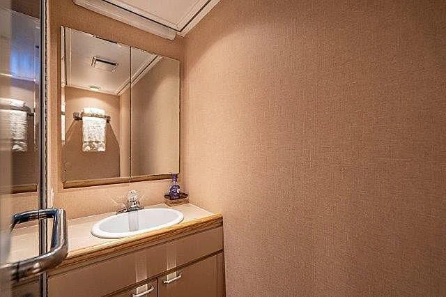a bathroom with a mirror and sink aboard IVORY LADY Yacht for Sale
