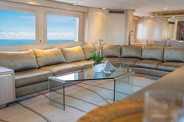 a living room with a large sofa aboard IVORY LADY Yacht for Sale