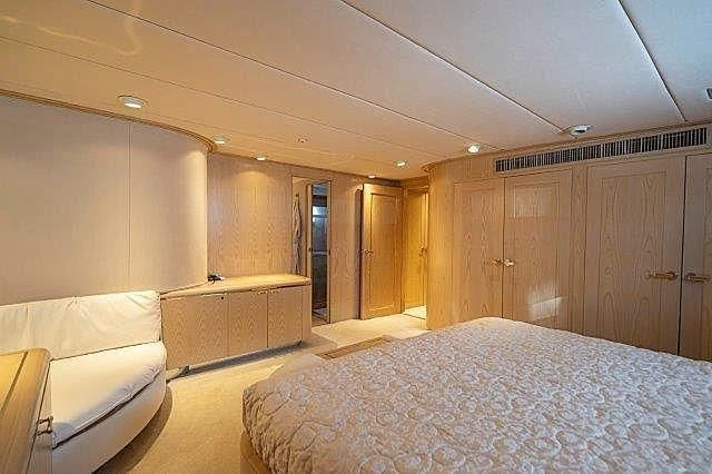 a bedroom with a bed and a large closet aboard IVORY LADY Yacht for Sale