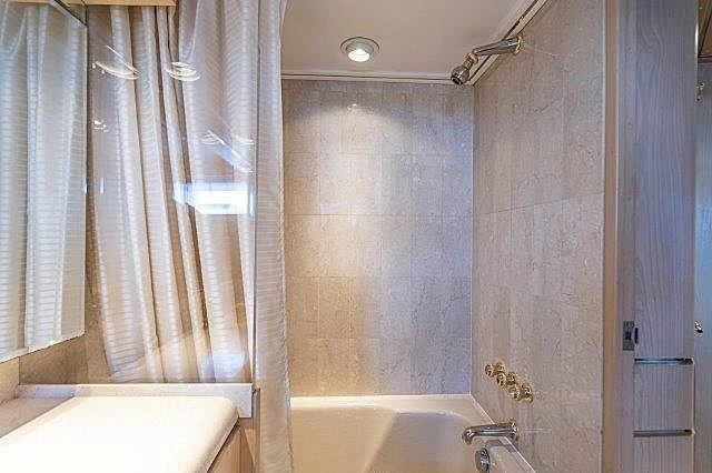 a bathroom with a bathtub and shower aboard IVORY LADY Yacht for Sale