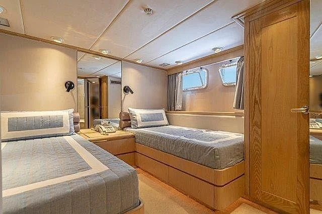 a room with a bed and a closet aboard IVORY LADY Yacht for Sale