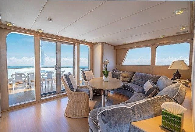 a living room with a large glass door aboard IVORY LADY Yacht for Sale