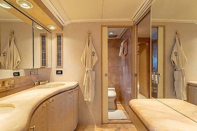 a bathroom with a tub sink and toilet aboard IVORY LADY Yacht for Sale