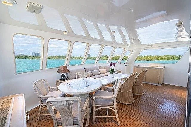 a room with a table and chairs aboard IVORY LADY Yacht for Sale