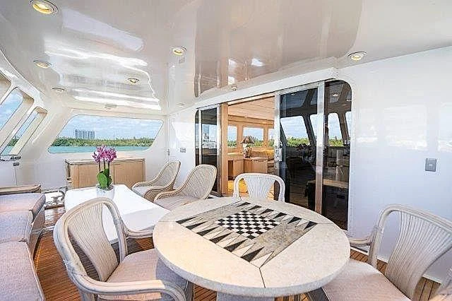 a room with a table and chairs aboard IVORY LADY Yacht for Sale