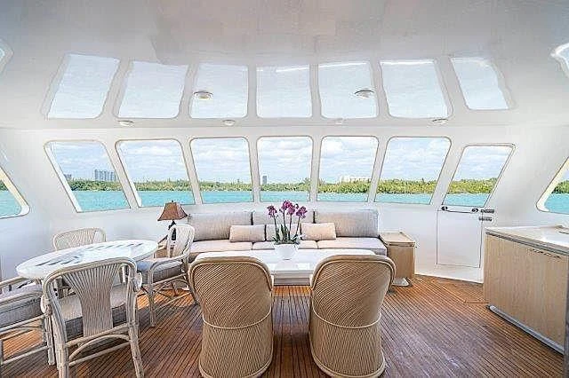 a room with a table chairs and a couch aboard IVORY LADY Yacht for Sale