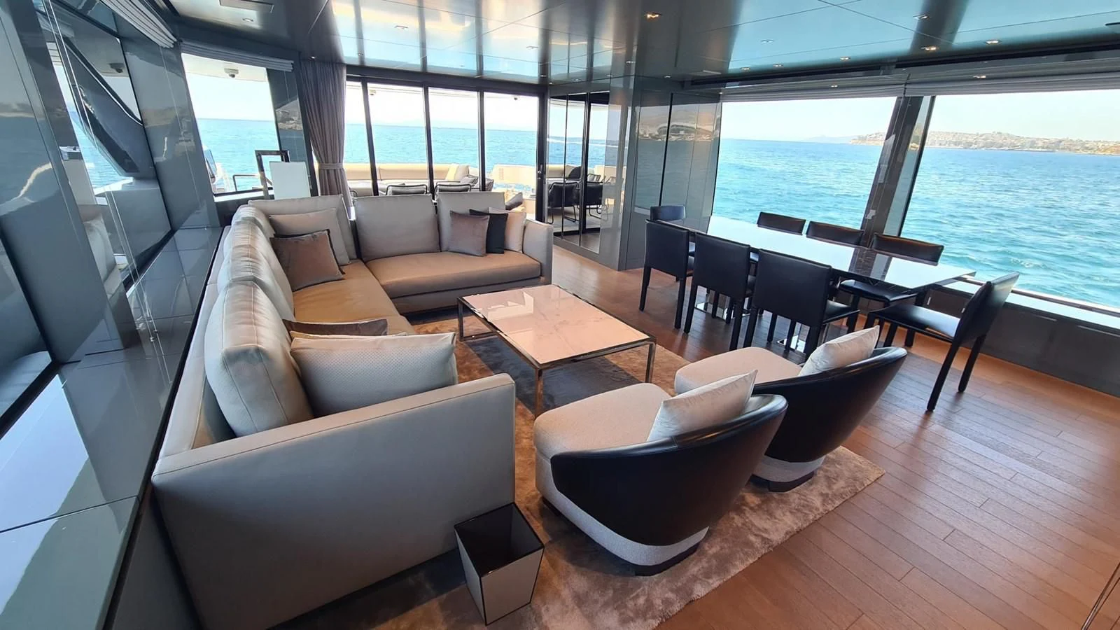 a room with a couch and a table and chairs aboard 2021 SANLORENZO SD96 #95 Yacht for Sale