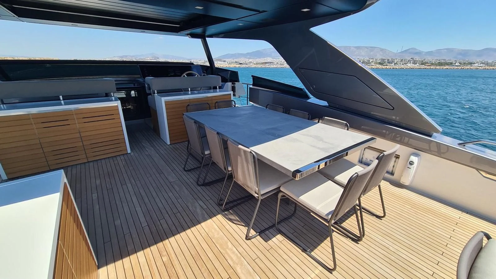 a deck with a table and chairs on it aboard 2021 SANLORENZO SD96 #95 Yacht for Sale