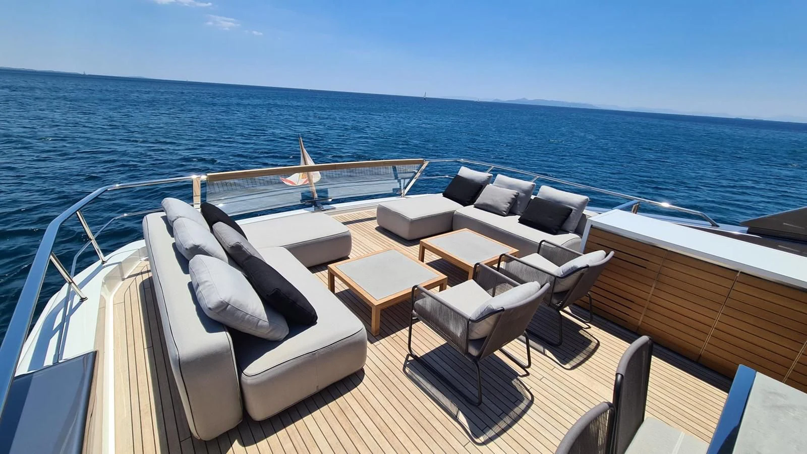 a boat with a lounge chair and a table on the deck aboard 2021 SANLORENZO SD96 #95 Yacht for Sale