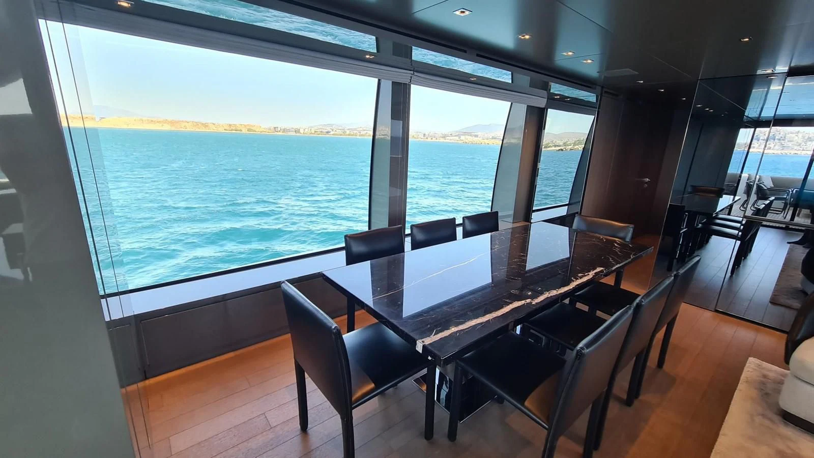 a room with a table and chairs aboard 2021 SANLORENZO SD96 #95 Yacht for Sale