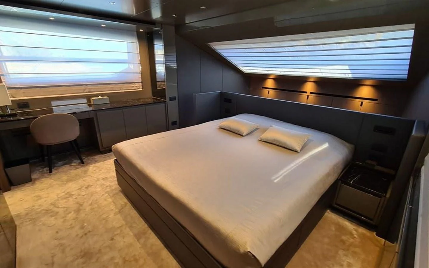 a room with a bed and desk aboard 2021 SANLORENZO SD96 #95 Yacht for Sale