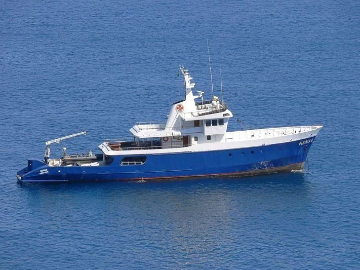 a large boat in the water aboard MAYA'S DUGONG Yacht for Sale
