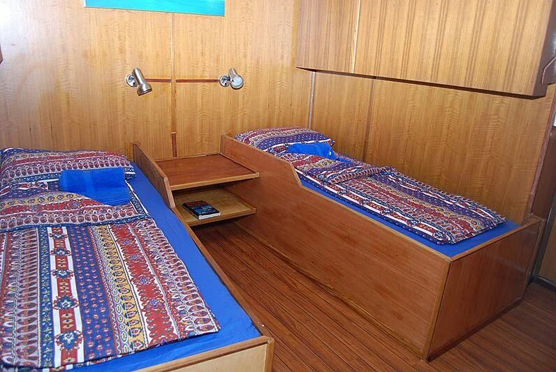 a couple of beds in a room aboard MAYA'S DUGONG Yacht for Sale